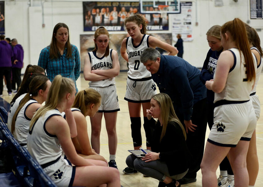 Maddy Hornecker (middle, crouched) was the head basketball coach of Evergreen High School before becoming the school's athletic director. Together, Hornecker helped lead  the Cougars to back-to-back state titles in 2017 and 2018.