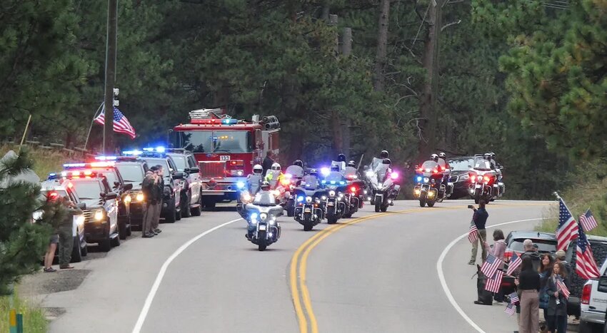 The funeral procession for Major Toby Lewis, who grew up in Conifer, moves through Marshdale on its way to Evergreen Memorial Park on Sept. 14. Area first responders and residents lined Highway 73 to pay their respects as the funeral procession went by.