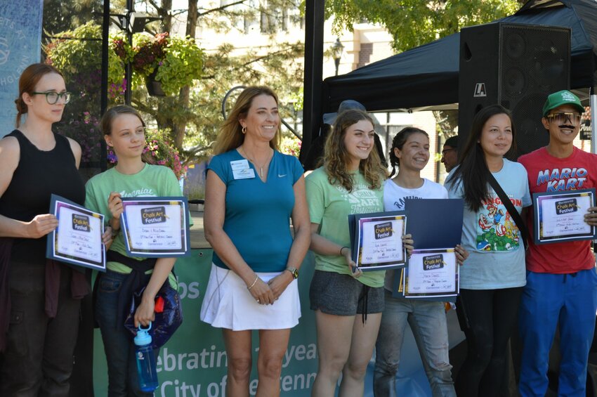 Centennial Mayor Stephanie Piko smiles alongside several award winners at the 2023 Centennial Chalk Art Festival.