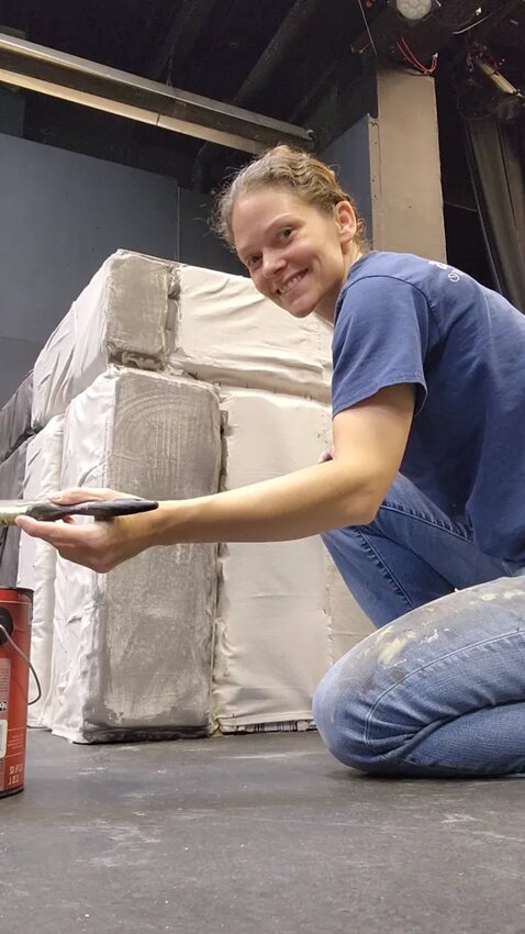Local theater artist Megan Davis paints the set for Firehouse Theater Company's upcoming production of “Dracula."
