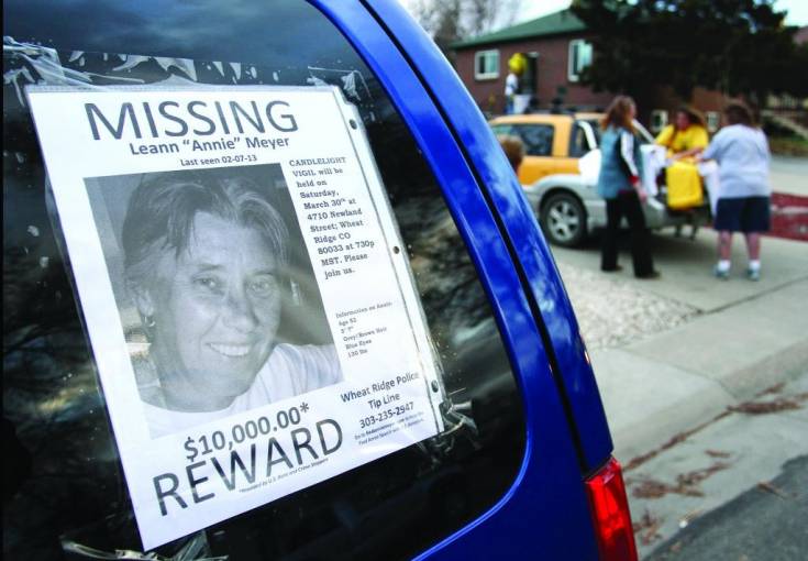 A flyer of missing Wheat Ridge resident Leann “Annie” Meyer is posted on the side of a vehicle as family and friends prepare for a candlelight vigil Saturday, March 30, at her 4710 Newland St. residence. Meyer had been missing since Feb. 7, 2013.