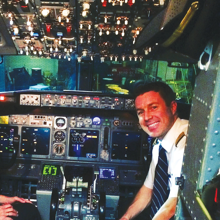 Matt Stege, co-pilot of a Boeing 737 for a major airline, gets his picture taken in the cockpit of the plane. Stege, 33, of Denver knew he wanted to be a professional pilot since he was 14.