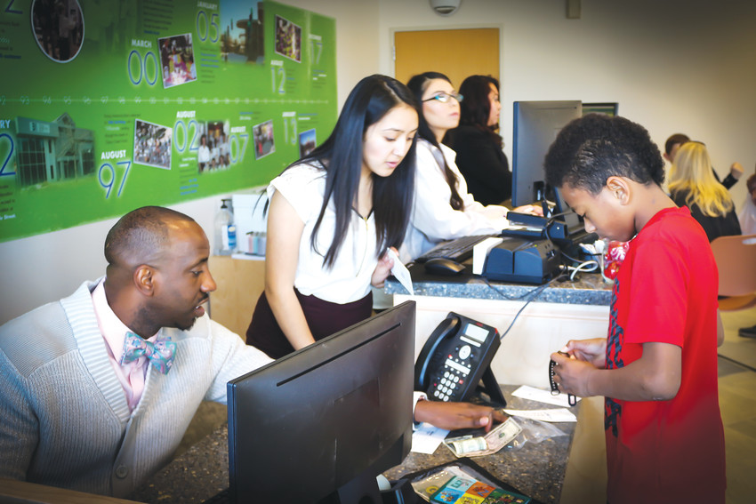 Bankers at the Young Americans Center for Financial Education help children set up checking or savings accounts. In addition to traditional banking services, the center also provides classes and seminars for children who want to learn more about financial stability.