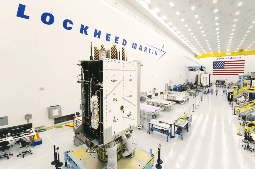 Technicians work on a global positioning system satellite at Lockheed Martin’s Waterton Canyon campus last August. Lockheed is one of the heavy hitters of the Colorado aerospace industry.