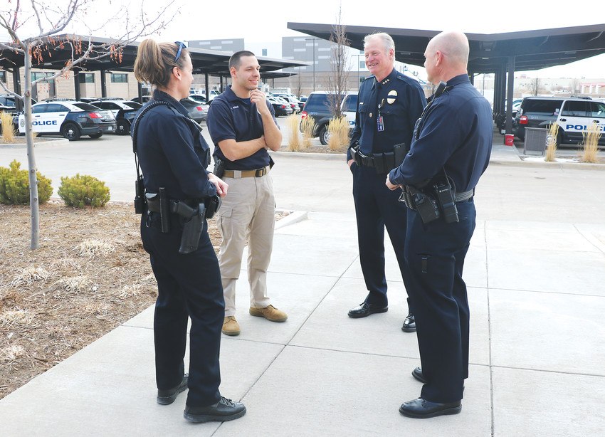 Parker Police Chief David King, second from right, talks with officers outside of the Parker police department, 18600 Lincoln Meadows Pkwy. His team has a large focus on mental health in the community.