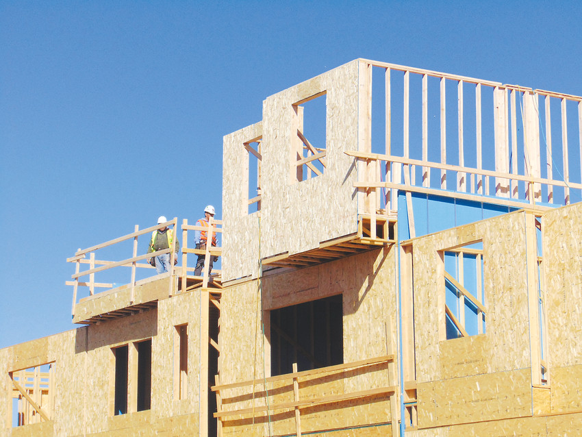 Workers frame townhomes at the Platte 56 development in Littleton on March 1. According to a new report, housing vacancy rates in the Denver metro area will remain critically low for the foreseeable future.