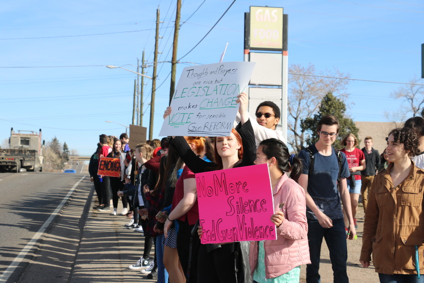 Lakewood High School students lined up along Kipling 
Street for 17 minutes on March 14, in remembrance of the 17 victims of the Parkland, Florida shooting, which was exactly one month ago. 
Students chanted "This is what democracy looks like," and "not one more" as cars honked as they drove by.
