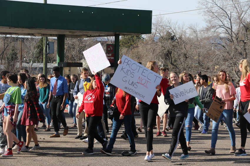 Students walked-out of Lakewood High School carrying a variety of signs urging action on gun violence on March 14, a month after the attack at Parkland, Florida.