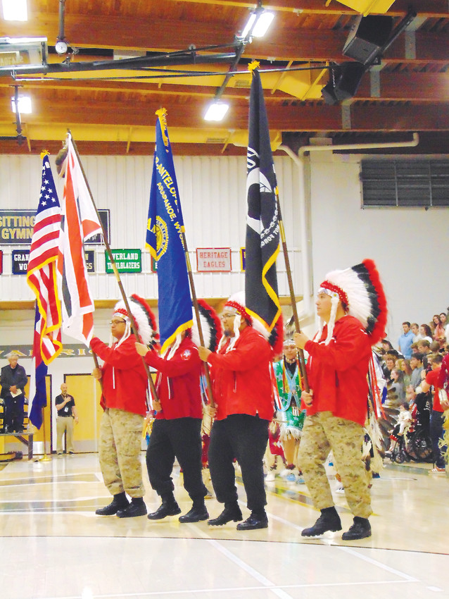 Members of the Arapaho Color Guard carry flags at the ceremony's outset.