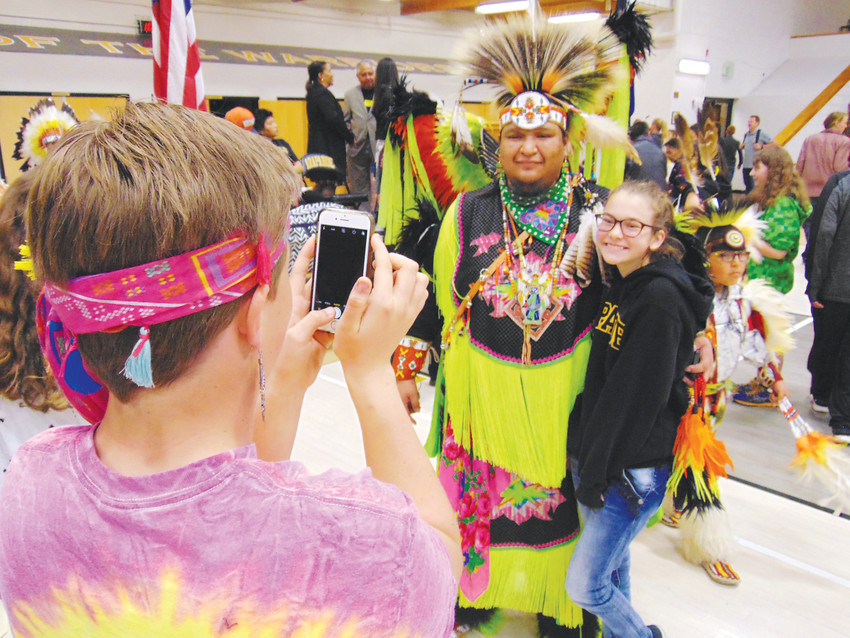 Arapahoe High School freshman  Beth Killinen poses for a photo with Arapaho dancer Dean Littleshield.