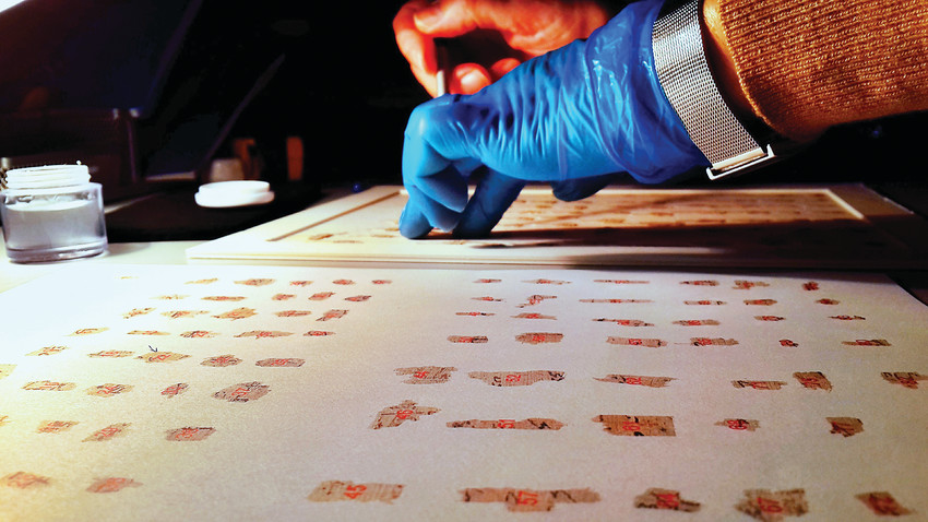 Conservators working at the IAA’s Dead Sea Scrolls Conservation Laboratory. The scrolls were discovered in 1947, and are making their first visit to Denver.