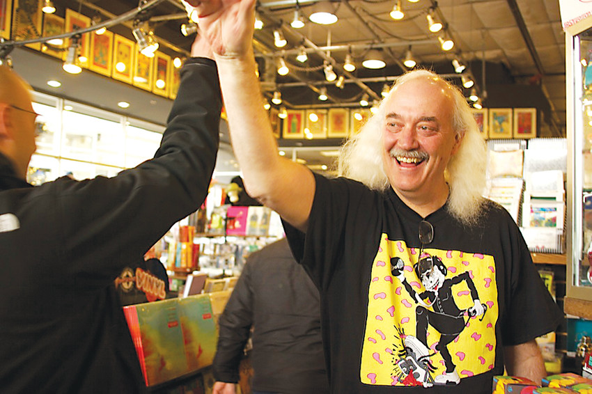 Paul Epstein, owner of Twist and Shout Records, high-fives the first customers into his store on Record Store Day. The annual event is an opportunity for vinyl fans to honor their favorite stores, and for store owners to thank their customers.