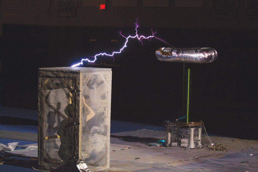 A Tesla Coil performance on Friday, the 13th was hopefully not unlucky for one person inside the cage being struck by lightning, during the annual E-Days activities.