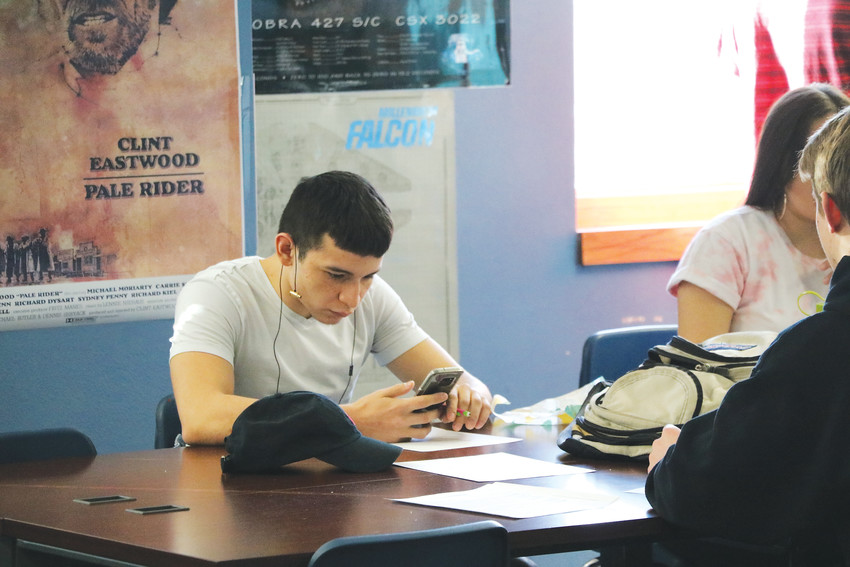 Dmitri Ramos, a senior at Highlands Ranch High School, checks his phone in class. Many of his peers often do the same. A national study in 2015 says nearly three-quarters of teens had a smartphone or had access to one, and 94 percent of teens went online with a mobile device daily.
