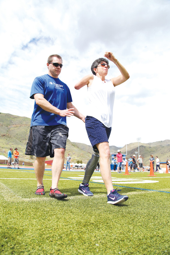 Ilene Brandon, of Highlands Ranch, works on walking with a Hanger Clinic coach. She has been an amputee for six years and wants to remember how to run.