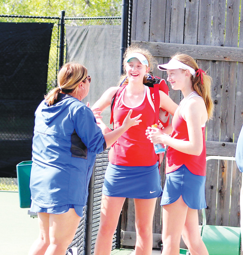 Cherry Creek coach Chris Jacob talks with freshman twins Nicole (center) and Eliza Hill after their semifinal matches at the Class 5A state tennis tournament on May 11 at the Gates Tennis Center.  Eliza won the No. 2 singles state championship and Nicole was the No. 3 single champ.