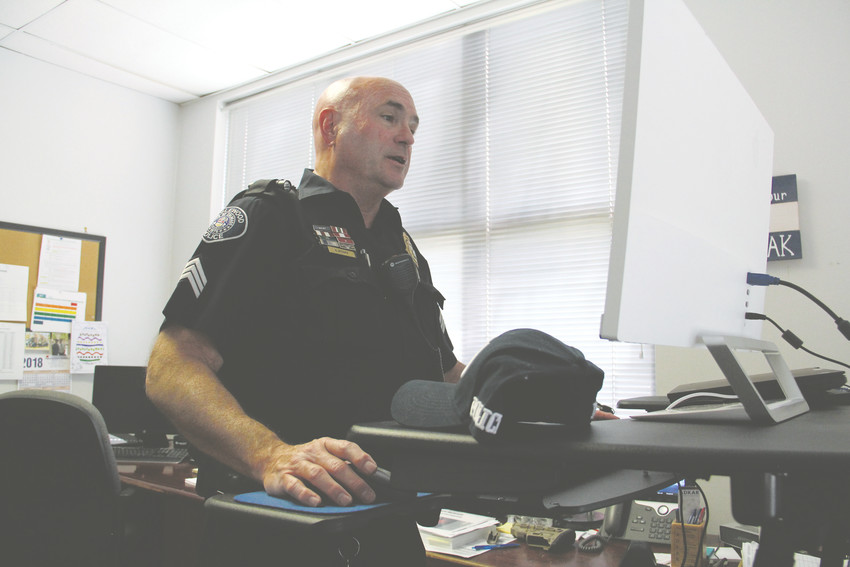 Englewood police Sgt. Reid McGrath, stands at his desk in his office April 25. Reid has been with the Englewood Police Department since 1992 and is a member of the Change the Trend Network, a coalition including nonprofits, churches and other entities working to address homelessness in Englewood.