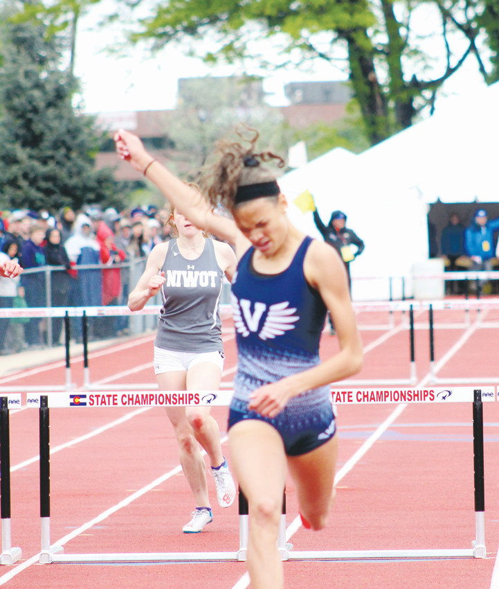 Valor Christian junior Anna Hall raises her hand after winning the Class 4A 300 hurdles on May 19 at the State high school track championships held at Jeffco Stadium. Hall also won the 100 hurdles and long jump and Valor Christian captured the 4A team title.