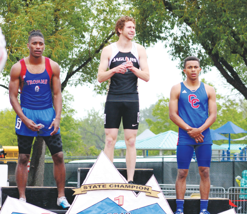 Class 5A 100-meter champion Devin Cadena of Rock Canyon is flanked by Cherry Creek's third-place finisher Marcus Miller, right, and second-place finisher Deondre Ritter of Fountain Fort Carson.