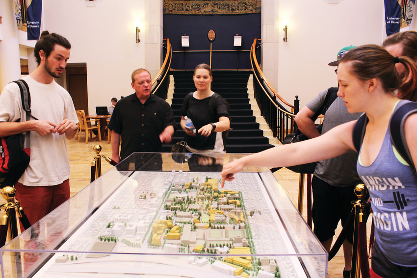 Students look at a model of campus, which shows new buildings included in a new development plan at the University of Denver.