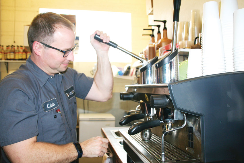 Chris Smith, the service advisor at Lube &amp; Latte in Lakewood, makes a latte on Oct. 4. The business opened in 2007 and offers Denver’s Novo Coffee and Sugar Bakeshop pastries.
