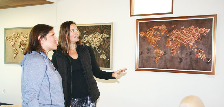 Golden artist Charlotte Bassin gives a guided tour of the art gallery at Canyon Point to Jackie Berz of Denver. Bassin’s Wander and Wonder World Maps are on display at Dr. Amy Shearer’s Canyon Point Orthodontics and Dr. Paul Madlock’s Canyon Point Implant and Oral Surgery in Golden.