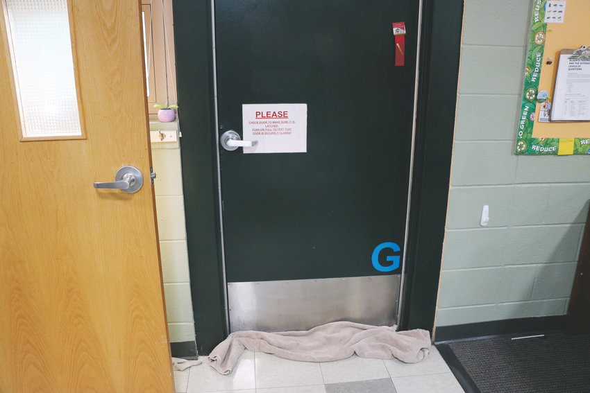 Teachers use towels to keep rainwater from flooding under classroom doors at Sedalia Elementary School. It’s one of DCSD’s two oldest schools.