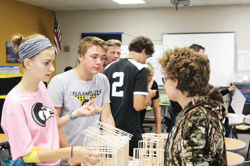 From left to right, Emma Hancock, Tyler McNeilly and Rose Gavin work together on a model of a house that Green Mountain High School’s Geometry and Construction program will design. The program won an award for excellence in education innovation.