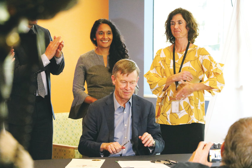 Gov. John Hickenlooper signs an executive order to curb teen vaping at a press conference at Children's Hospital Colorado on Nov. 2.