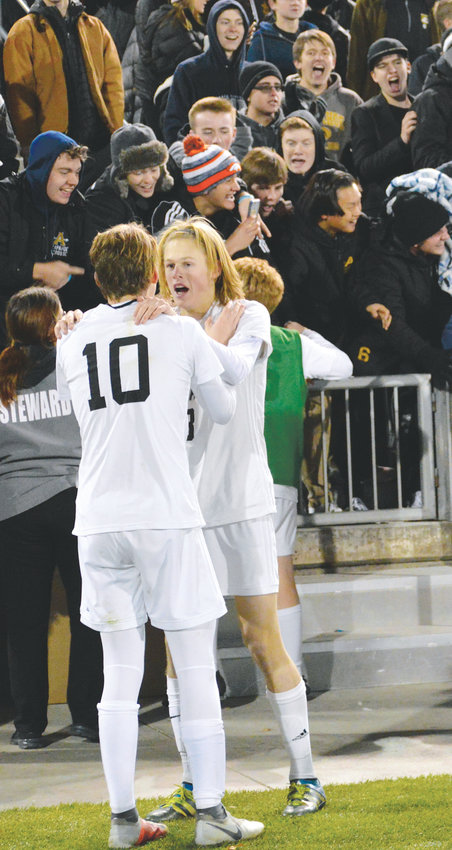 Arapahoe players celebrate after a 2-1 win over Grandview on Nov. 9 gave the school its sixth boys soccer championship but the first one since 1997. The Warriors finished the season with a 17-1-2 record.