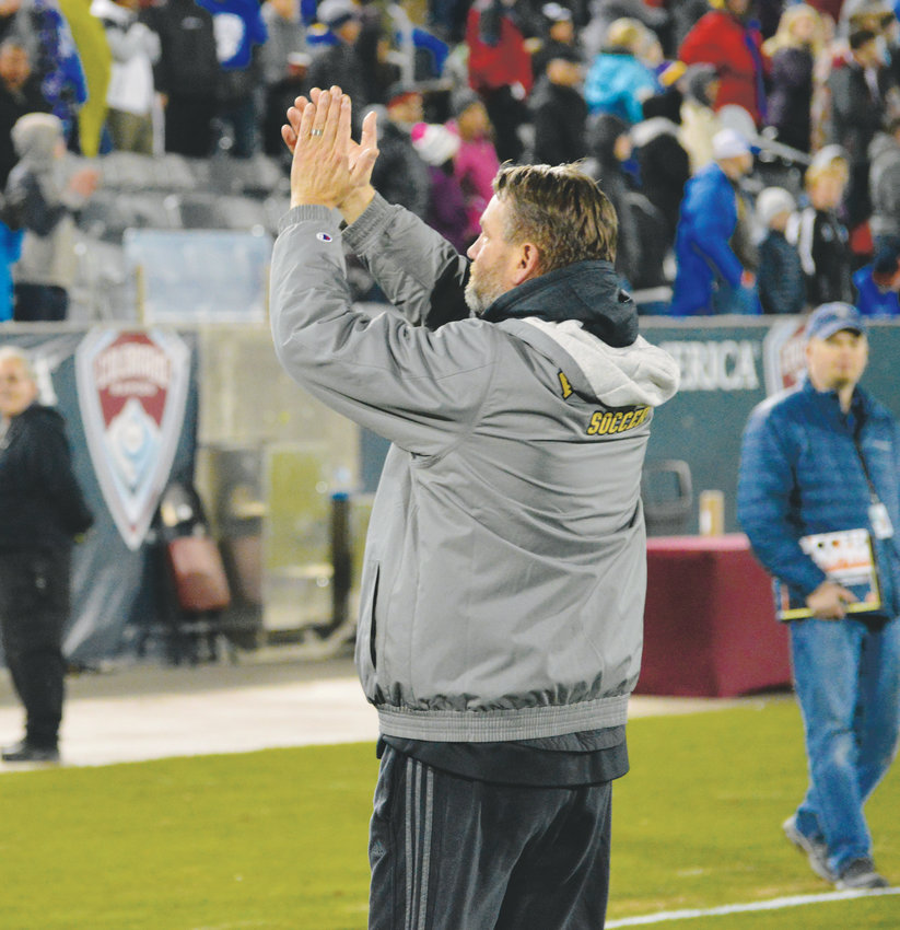 Arapahoe coach Mark Hampshire acknowledges the Arapahoe crowd that showed up at Dick's Sporting Goods Park on Nov. 9 to support the Warriors who won the 5A state championship with a 2-1 victory over Grandview.