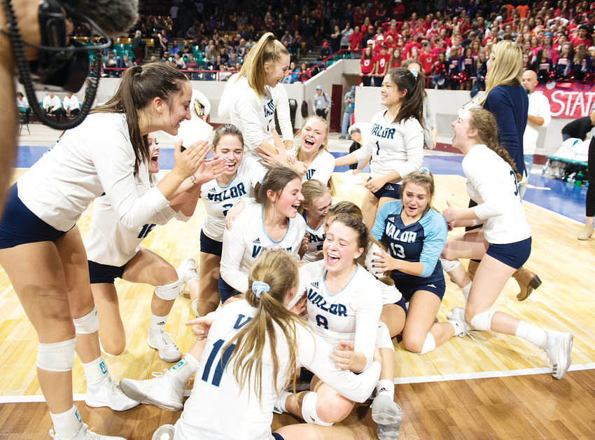 The Valor Christian volleyball team ends up on the floor as the players celebrate their first State Championship after defeating Chaparral 3-1 on Nov. 10 at the Denver Coliseum.