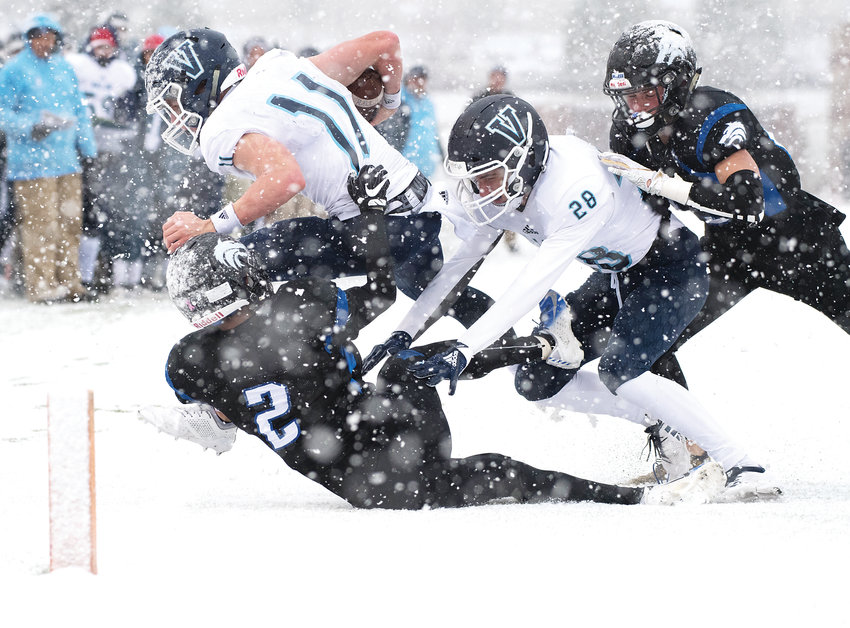 Valor Christian's Jack Howell (11) gets forced out of bounds just before the goal line marker as Grandview defenders Quentin Goodgain (2) and Kyle Trumble (23) along with Howell's blocker Dane Pallazo (28) follow him out. Despite near-white out conditions in the second half, the Eagles ended up on top to get the 31-29 victory, punching their ticket for the Dec. 1 5A state championship game at Broncos Stadium at Mile High.