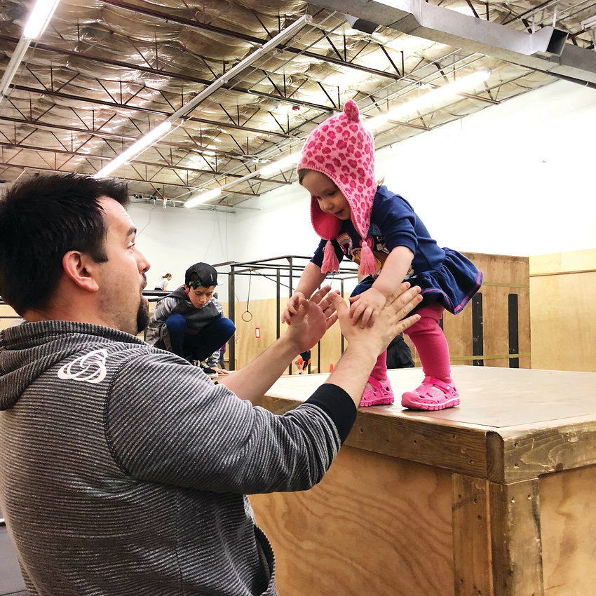 Ken Arrington plays with daughter Addie at Path Movement in Littleton. Arrington founded Path Movement in 2013.