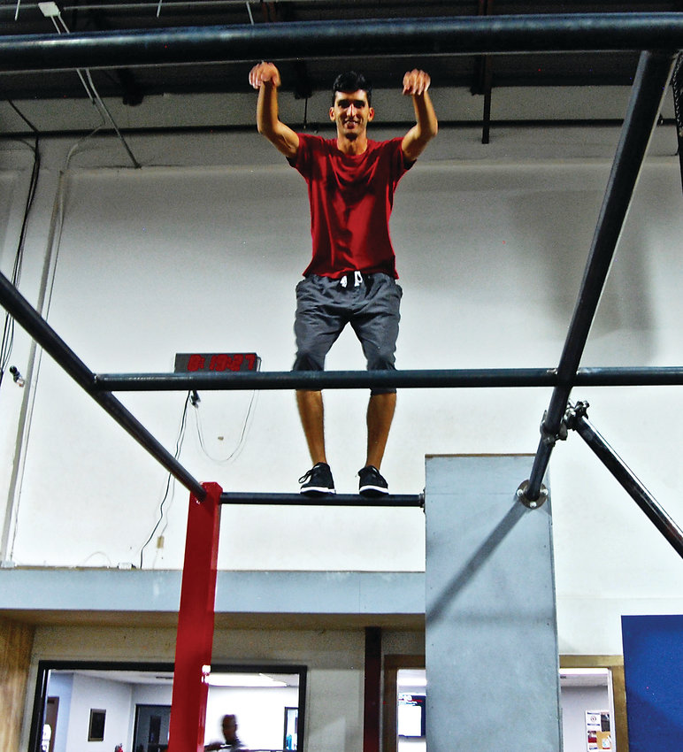 Vinny Fiacco on the rails at APEX Movement, the parkour gym in Denver at which he is co-owner and general manager.