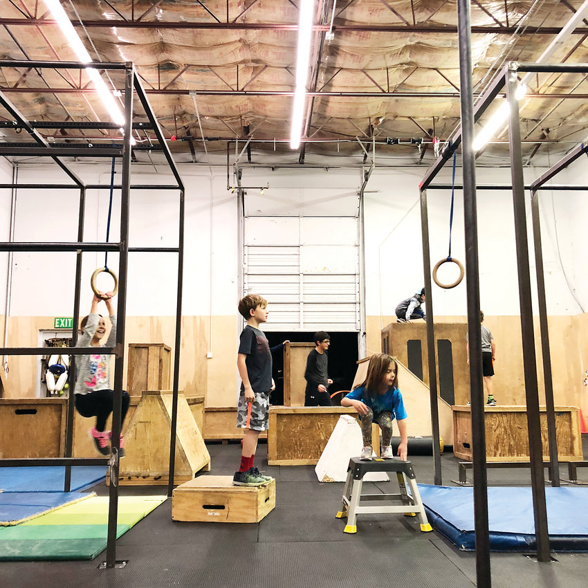 The kids of Path Movement take turns on the rings during class. “I’d say our youngest participant is about 5, and our oldest is 68,” owner Ken Arrington said.