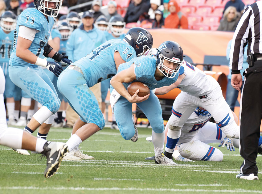 Valor Christian quarterback Luke McCaffrey runs the ball as teammate Ethan Zemla (54) seals off a potential tackler against Cherry Creek in the 5A state championship game on Dec. 1.