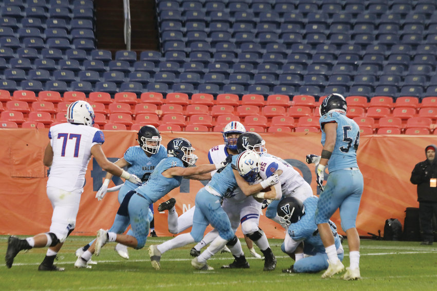 Valor defenders swarm in to stop Cherry Creek running back Shamus Henderson during the Dec. 1 Class 5A state championship game.