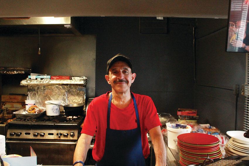Nick Andurlakis poses behind the counter of Nick’s Cafe. The restaurant is known for its Fool’s Gold sandwich.