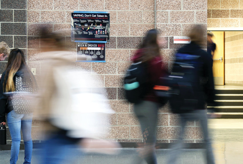 Students at Lakewood High School walk past vaping education posters in the hallway. The Colorado Department of Public Health and Environment says Colorado is first in the nation for the number of teenagers who use vaporizers or e-cigarettes, calling the trend a public health crisis.