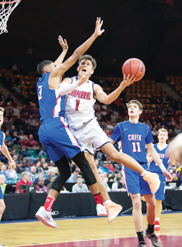 Chaparral’s Kobe Sanders (1) drives the lane as Cherry Creek’s Julian Hammond defends. The Wolverines held on to win the 5A Great 8 game 67-62 March 2 at the Denver Coliseum.