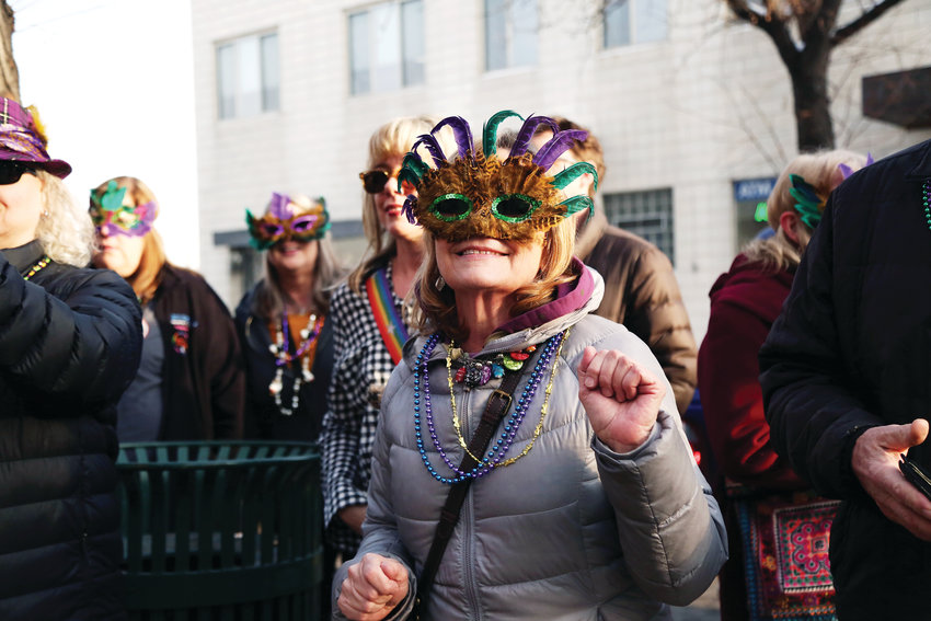 Patty Gleich, of Arvada, dances to the tunes of Brothers of Brass during the Fat Tuesday parade in Olde Town Arvada.