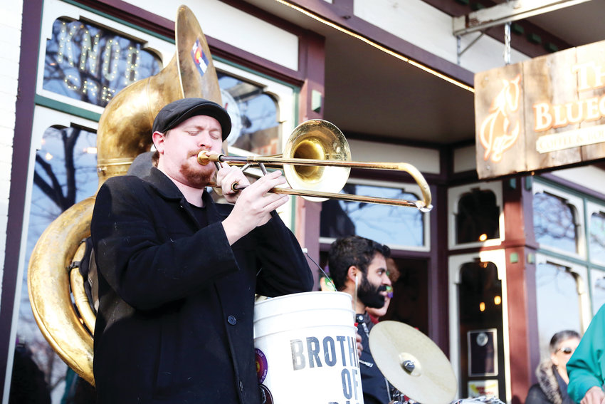 Ethan Harris plays trombone with Brothers of Brass during the Fat Tuesday kickoff parade in Olde Town Arvada.