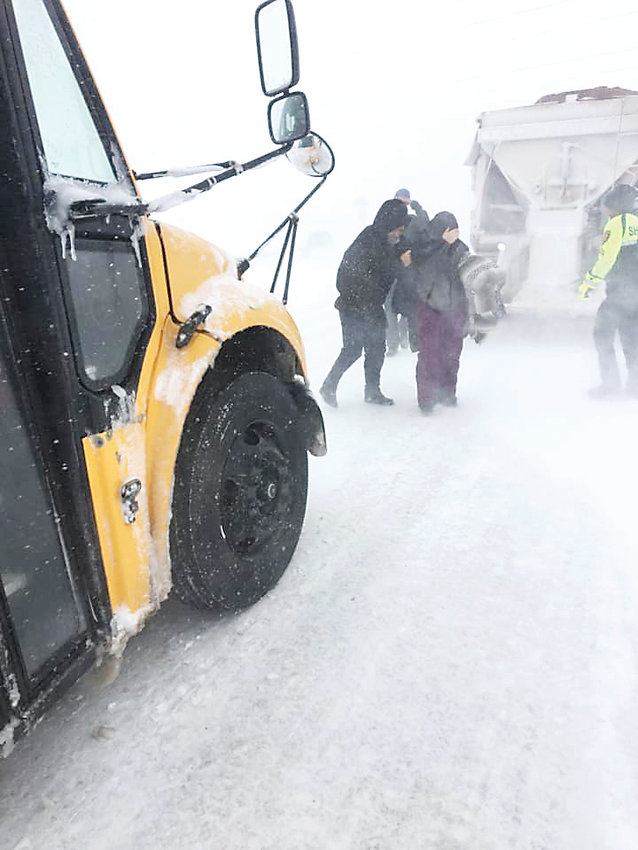 In response to treacherous travel conditions, Douglas County School District deploys school buses to rescue stranded motorists along I-25, among other highways. The winter storm, which officials dubbed a bomb cyclone, hit the metro area March 13.