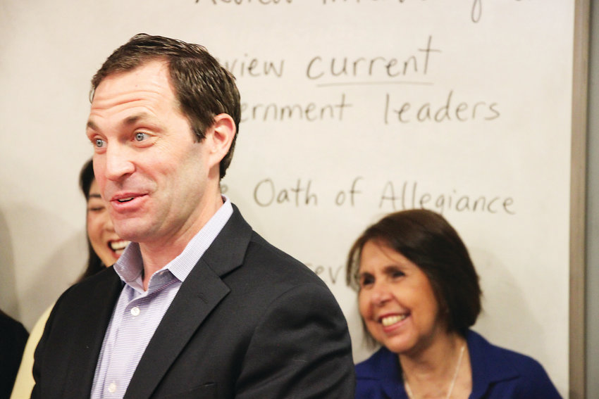 U.S. Rep. Jason Crow, left, speaks to a citizenship class at the Littleton Immigrant Resource Center on April 15, while center director Glaucia Rabello looks on. Crow visited during a challenging time for the center, which lost a federal grant last year and is fighting fears among legal immigrants about pursuing citizenship.