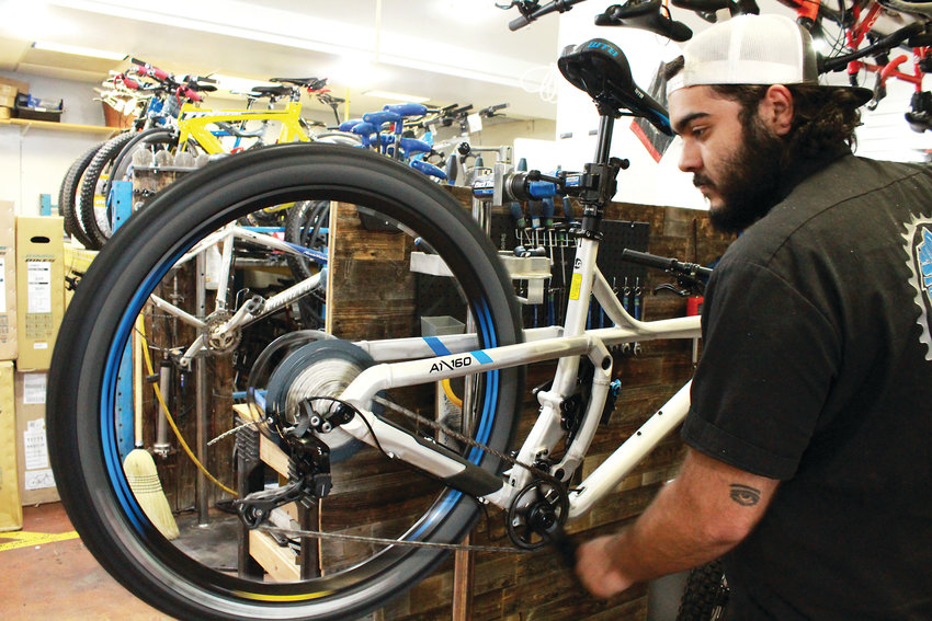 Paul Rodriguez, owner of the Bicycle Shack in Arvada, works on a bike.