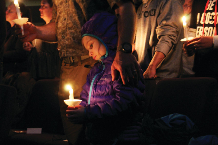 A girl holds a candle during the prayer service at Mountainview Church in Highlands Ranch May 8, memorializing the victims of the STEM School shooting May 7.