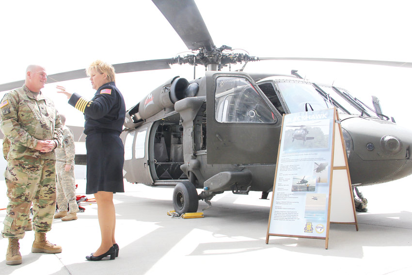 Rock Creek Volunteer Fire Department Chief Brita Horn, right, talks to Col. Will Gentle, director of aviation for the Colorado Army National Guard, on May 7 next to a Blackhawk helicopter from Buckley Air Force Base in Aurora. The aircraft provides “water buckets,” rescue hoisting and a medical evacuation kit that aid in responding to wildfires.
