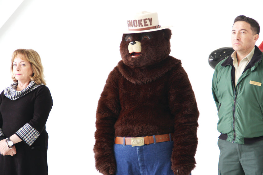 Smokey Bear, the federal government’s mascot for wildfire prevention, stands next to Lt. Gov. Dianne Primavera, left, and other officials May 7 at the state’s 2019 wildfire outlook event.