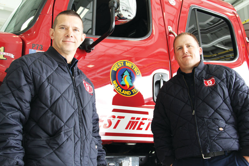 Firefighter Shawn Botsford, left, and Tony Lodice, engine boss for West Metro Fire Rescue, stand next to a West Metro truck May 7 at Centennial Airport after Colorado’s 2019 wildfire outlook event. Botsford and Lodice are on West Metro’s wildfire team.